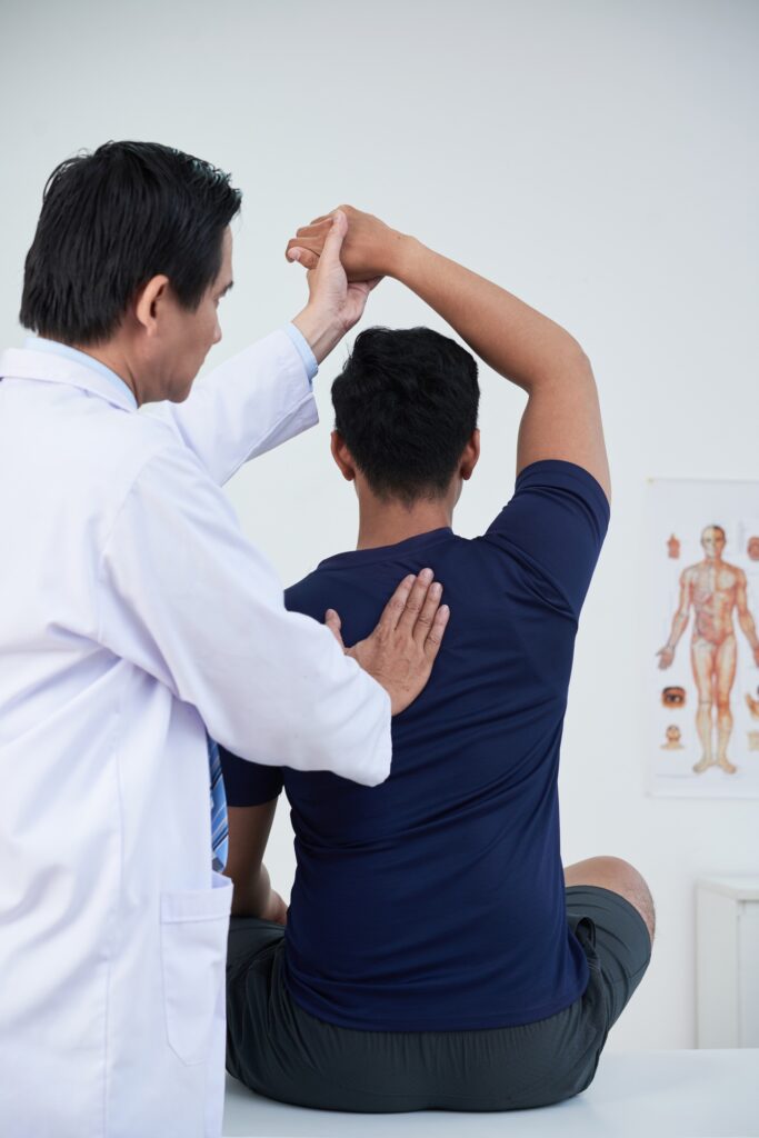 Professional Osteopath At Work With Patient